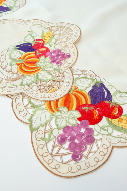 Decorative placemats with fruit and vegetable designs on a wooden surface