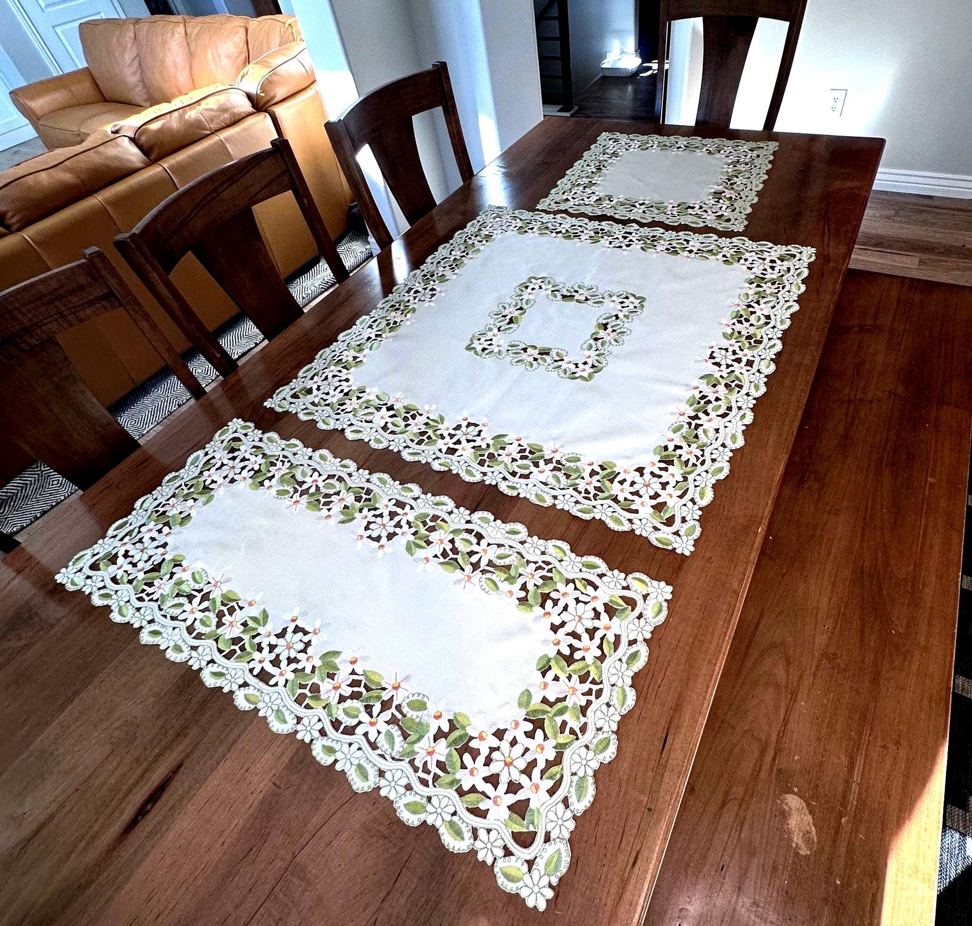 daisy collection of embroidered cutwork.  the perfect  table toppers 36”. square, 20” square and 15 x 36” runner are the perfect addition to your everyday linens